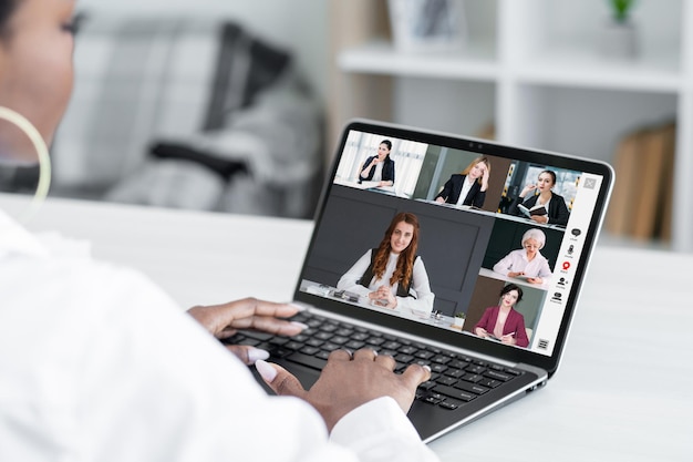 Online-Konferenz Virtuelles Meeting Fernkooperation Geschäftsfrau mit Laptop bespricht Projekt mit Team auf dem Bildschirm im digitalen Büro