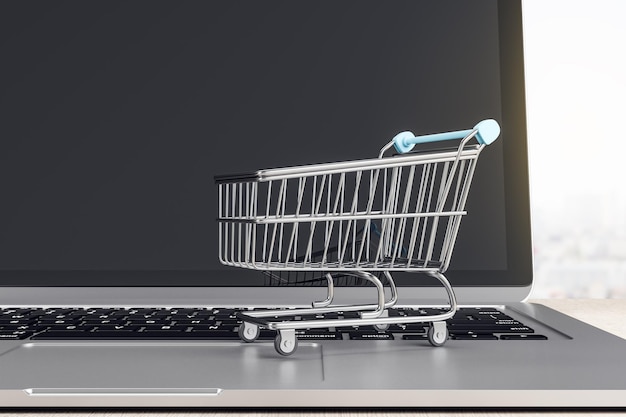 Online-Shopping-Konzept mit Mini-Wagenladen auf der Laptop-Tastatur
