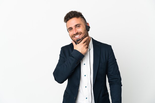 Operador de telemarketing trabalhando com um fone de ouvido isolado no fundo branco feliz e sorridente