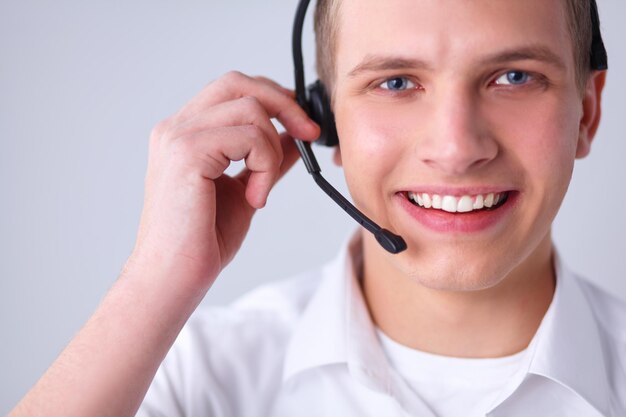 Operador de soporte al cliente con un auricular sobre fondo blanco.