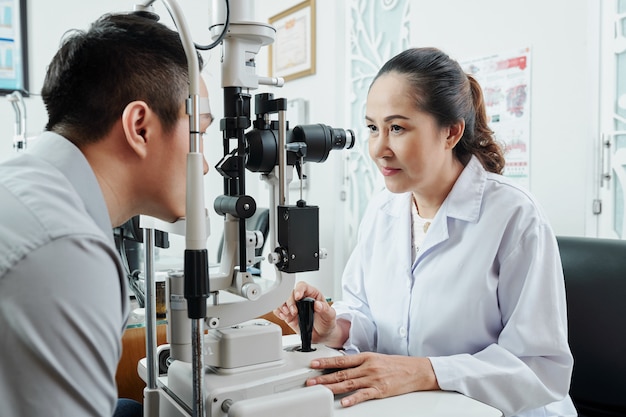 Optometrista asiático trabajando en oficina