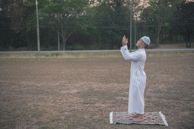 Oração do homem islâmico branco asiáticoJovem muçulmano rezandoConceito do festival do Ramadã