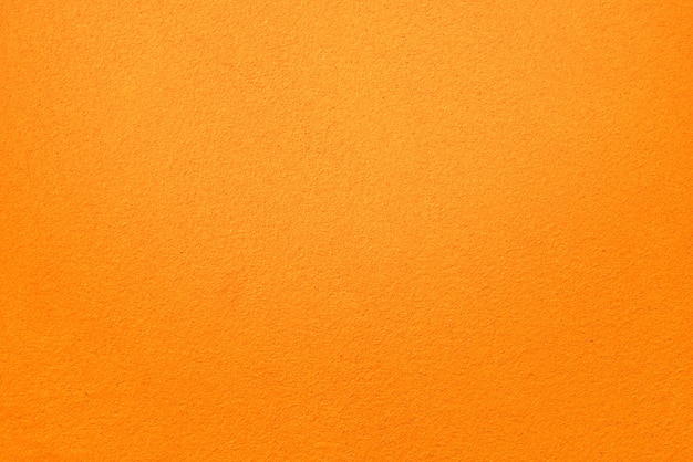 Orange Farbe Betonwand Textur Hintergrund. Fein raue Betonoberfläche.