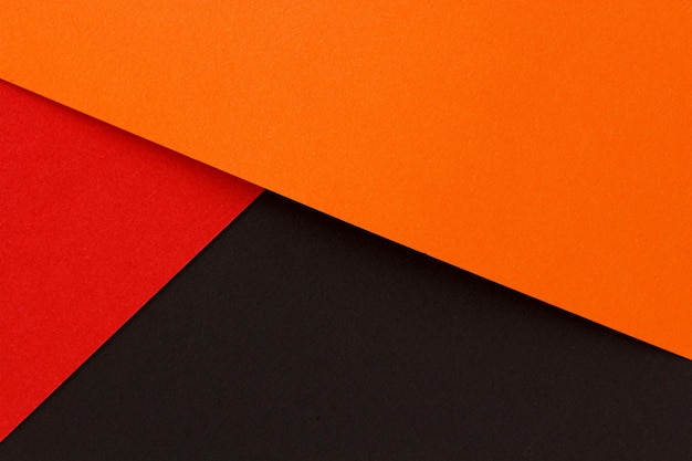 Orange rote und schwarze Farbe Papier flach Hintergrund legen