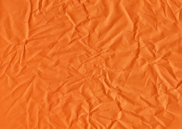 Orangefarbene Papierstruktur mit kleinen Falten