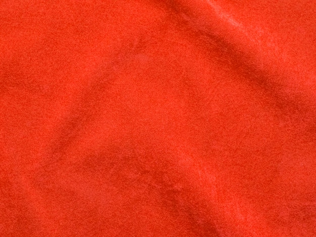 Orangefarbener Samtstoff als Hintergrund verwendet Leerer orangefarbener Stoffhintergrund aus weichem und glattem Textilmaterial Es gibt Platz für Text