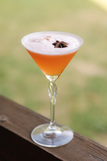 Orangenalkoholischer Cocktail mit Limonadenchampagner oder Martini mit Schaum und mit Sternanis dekoriert