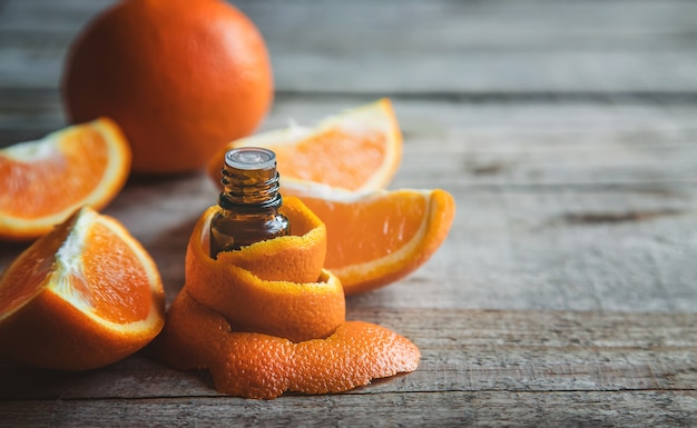 Orangenöl in einer kleinen Flasche. Selektiver Fokus. Essen.