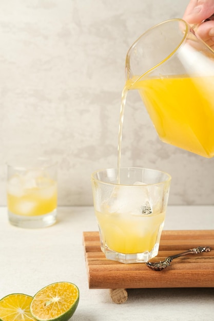 Orangensaft im Glas mit frischen Früchten auf dem Tisch Selektiver Fokus und unscharfer Hintergrund