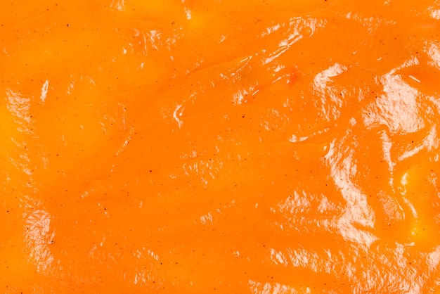 Orangensauce spritzt als Hintergrund