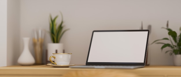 Ordenador portátil moderno con soporte de maqueta de pantalla en blanco sobre mesa de trabajo de madera con decoración moderna 3d