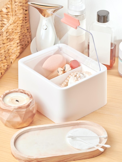 Organizador de plástico blanco para productos cosméticos, maquillaje y accesorios, interior de salón de belleza.