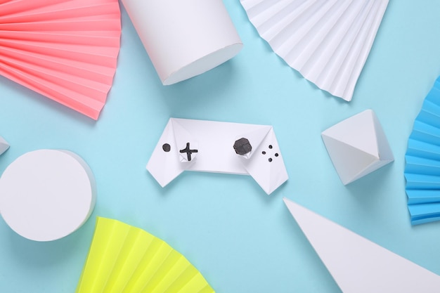 Origami-Gamepad auf abstraktem Hintergrund mit geometrischen Formen Minimalismus Konzeptkunst Kreatives Layout