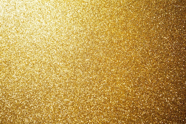 Foto oro, fondo de luz abstracto amarillo, luces brillantes de oro bokeh, luces de navidad brillantes y brillantes. fondo de saludo de temporada. imagen de fondo de lujo de año nuevo. fondo de vacaciones abstracto borroso.