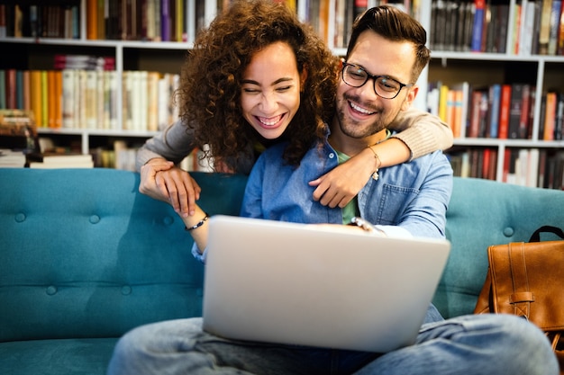 Os alunos estão estudando juntos na biblioteca. Casal, estudo, tecnologia, conceito de amor na educação