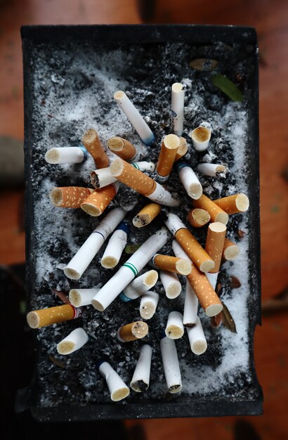 Os cigarros são deixados no cinzeiro na área de fumantes