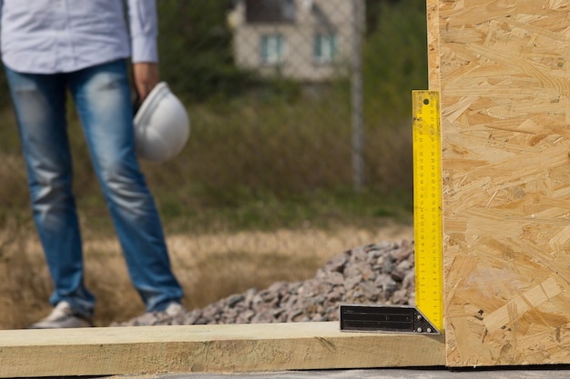 Os construtores tentam usar o ângulo reto ou quadrado em um canteiro de obras para garantir que um painel de parede de madeira seja exatamente perpendicular