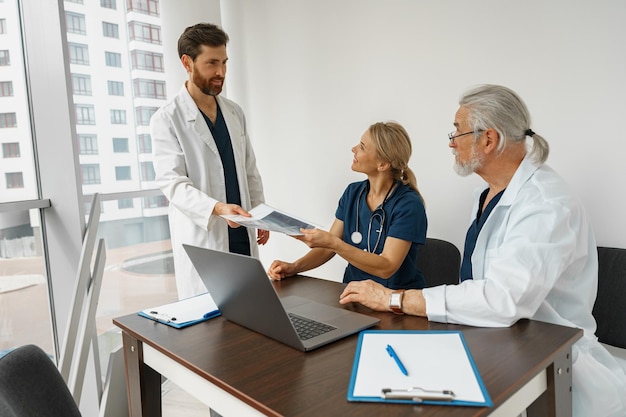 Foto os médicos bem sucedidos estão discutindo o diagnóstico durante a conferência