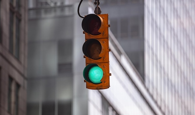 Foto os semáforos verdes para carros desfocam o fundo dos edifícios de escritórios