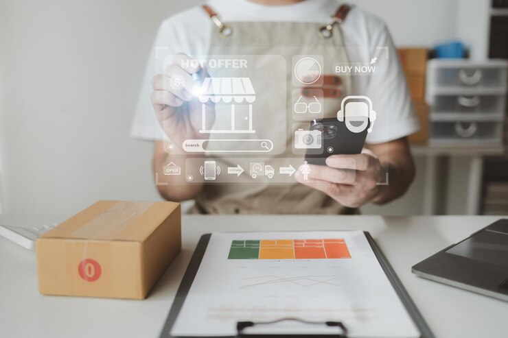 Foto os smartphones estão sendo usados para fazer várias atividades para promover as vendas às lojas. o proprietário de uma loja on-line embala produtos em caixas de encomendas com base em pedidos de sites de vendas on-line.
