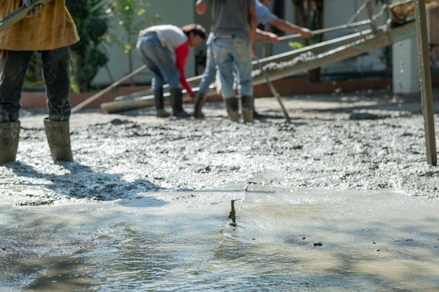 Os trabalhadores estão derramando concreto e equipamentos