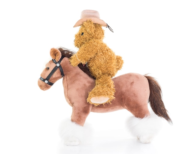 Foto oso de peluche vaquero a caballo