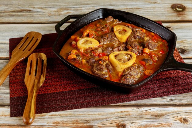 Ossobuco italienisches Gericht mit Rinderhaxe, Paprika, Zwiebel und Wein.