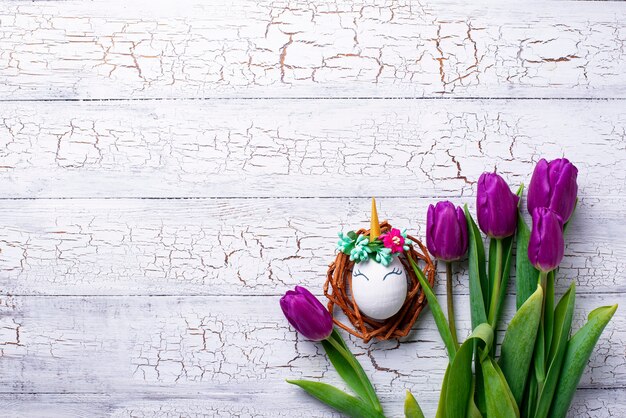 Ostern-Hintergrund mit Tulpen- und Einhörnereiern