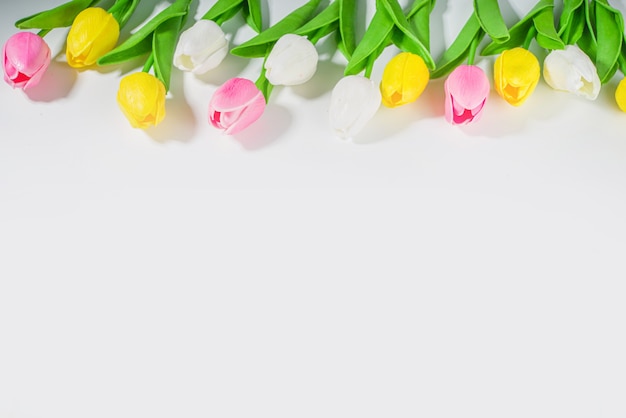 Ostern Hintergrund Tulpenstrauß, großer bunter Tulpenblumenstrauß auf weißem Tischhintergrund Draufsicht kopieren Raum für Text. Frühlingsferienblumenmuster