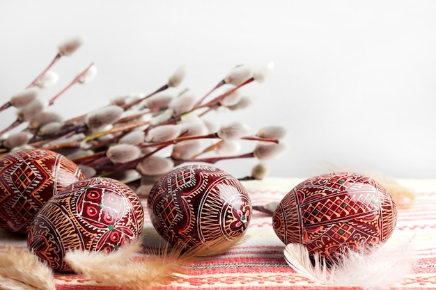 Ostern Stillleben mit Pysanka auf traditionellem ukrainischem Stoff. Dekorierte Ostereier, traditionell für die osteuropäische Kultur