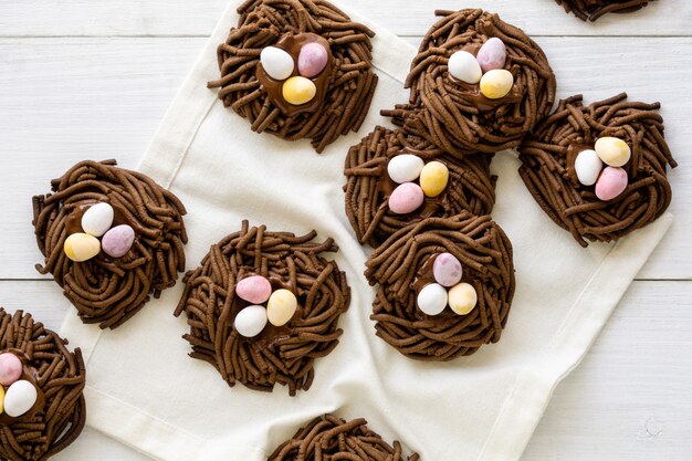 Osterschokoladenplätzchen. Nester mit süßen Eiern auf weißem Hintergrund.