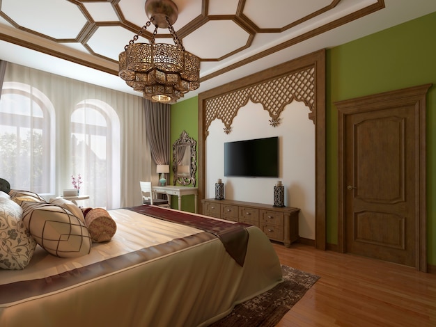 Ostschlafzimmer im arabischen Stil, Holzkopfteil und grüne Wände. TV-Gerät, Schminktisch, Sessel mit Couchtisch.
