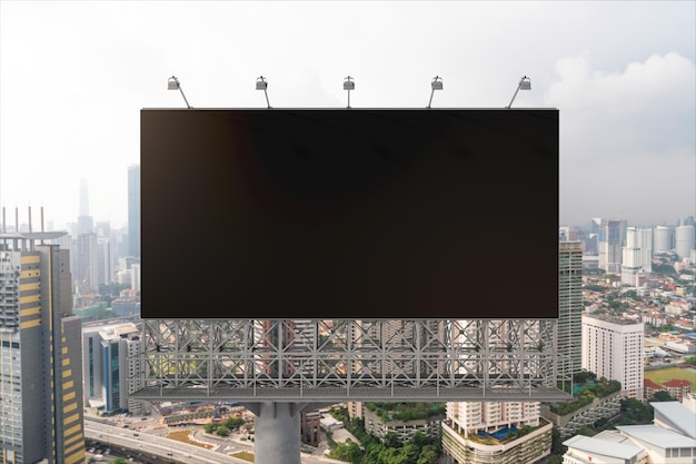 Outdoor de estrada preta em branco com fundo de paisagem urbana de Kuala Lumpur durante o dia Cartaz de publicidade de rua simula renderização em 3D Vista frontal Conceito de marketing para promover ou vender serviços ou ideias