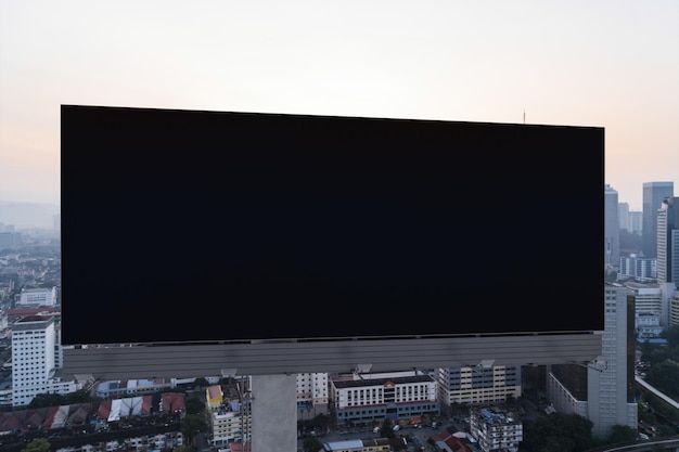 Outdoor de estrada preto em branco com fundo de paisagem urbana de Kuala Lumpur ao pôr do sol Cartaz de publicidade de rua simula renderização em 3D Vista frontal O conceito de comunicação de marketing