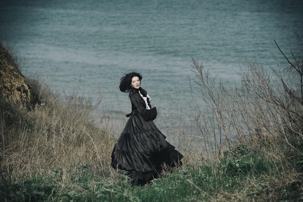 Outdoor-Porträt einer viktorianischen Dame in Schwarz Lauf weg und drehte den Kopf