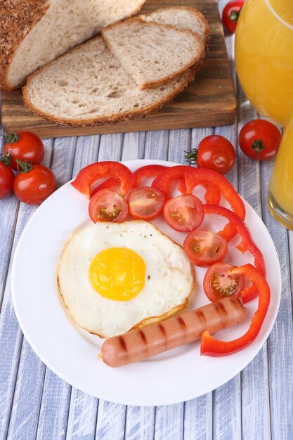 Ovo mexido com pão vegetal e salsicha servido em prato fundo de madeira