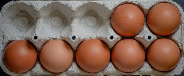 Foto ovos de galinha frescos em uma bandeja de papel na mesa foco seletivo