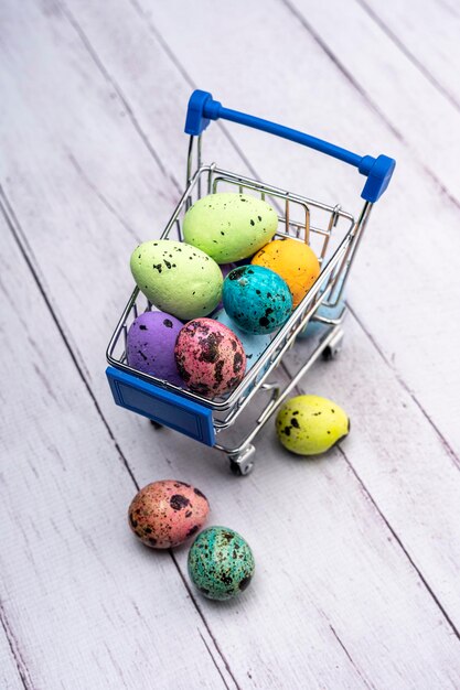 Ovos de Páscoa coloridos em um carrinho de supermercado Cartão de saudação de Páscoa