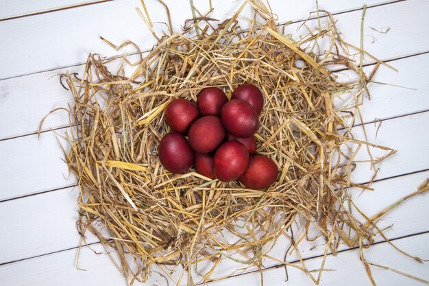 Ovos de Páscoa em um ninho de palha no fundo de madeira rústico. Feliz Páscoa!