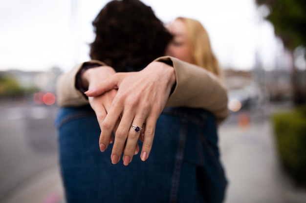 Foto paar draußen in der stadt nach heiratsantrag mit verlobungsring