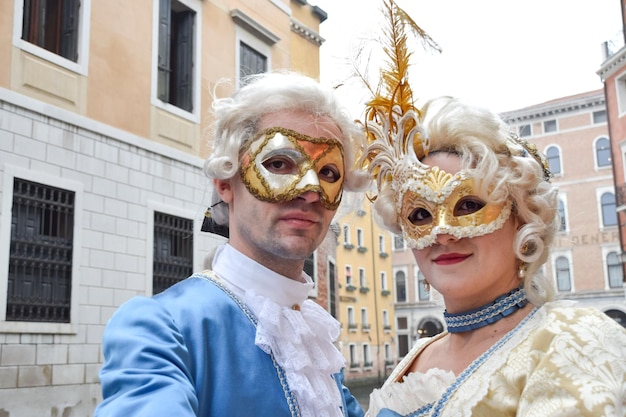 Paar verkleidet für den Karneval in Venedig in zeitgenössischer Kleidung