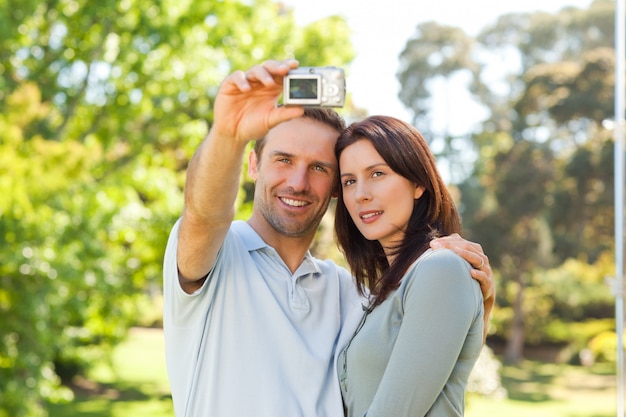 Paare, die ein Foto von selbst im Park machen