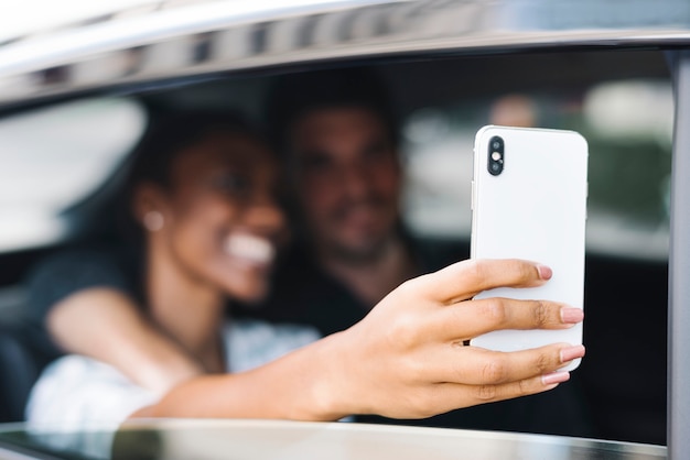 Paare, die selfie in einem Auto nehmen