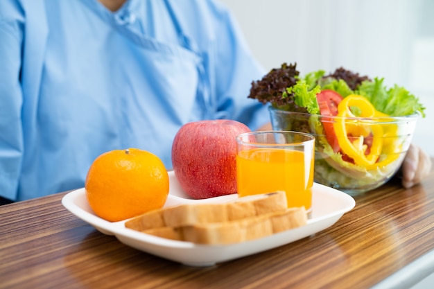 Paciente asiática idosa tomando café da manhã com vegetais saudáveis no hospital