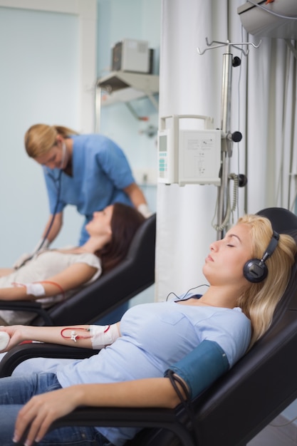 Paciente femenino escuchando música durante la transfusión