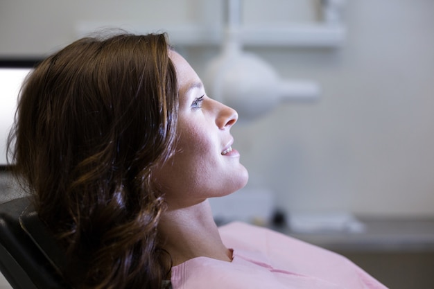 Paciente femenino sentado en la silla del dentista