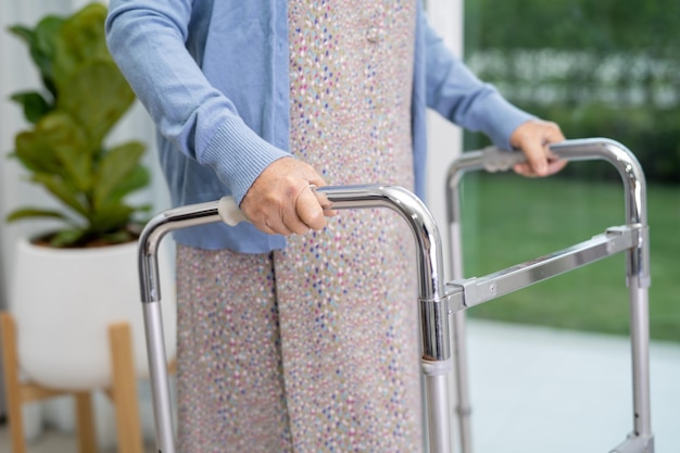 Paciente idosa asiática ou idosa caminha com caminhante na enfermaria do hospital de enfermagem conceito médico forte e saudável