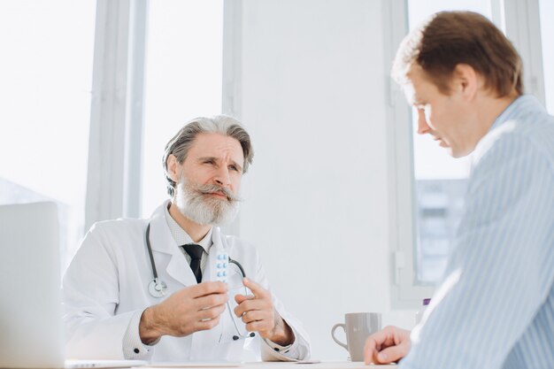 Paciente que tiene consulta con el médico senior en el consultorio