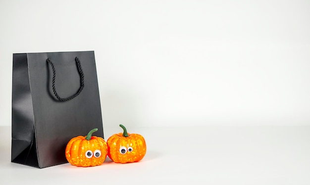 Packer negro con calabazas sobre un fondo claro El concepto de compras Halloween