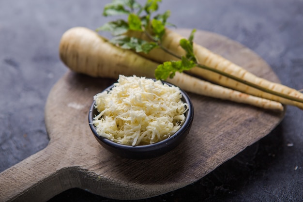 Pacote de pastinaga orgânica fresca sobre a superfície cinzenta da textura.